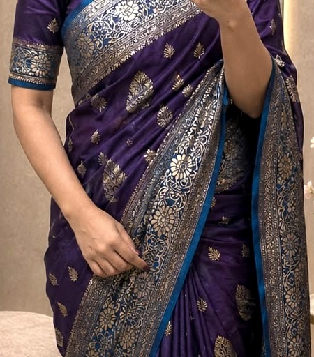 Close-up of the meenakari border and gold zari booti on a Banarasi silk saree